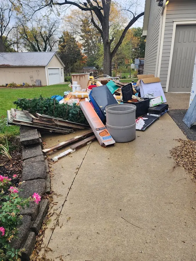 Dumpster being loaded with debris for 30 Yard Dumpster Rental in Farm Loop